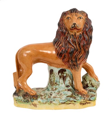 Lot 290 - Victorian Staffordshire pottery model of a standing lion, circa 1860, polychrome decorated, 15cm high x 23cm wide