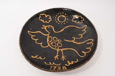 Lot 294 - Slipware dish, decorated with a bird in yellow slip on a brown ground, inscribed '1728' but dates from later, piecrust rim, 36cm diameter