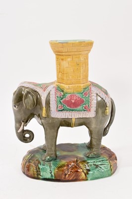 Lot 295 - Late 19th century majolica 'elephant and castle' spill vase, the elephant modelled standing on a naturalistic base, 19.5cm high