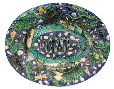 Lot 299 - Large 19th century French Palissy style majolica oval dish, decorated in relief with a snake, fish, frog, crayfish, shells, and insects, 44cm wide