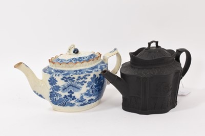 Lot 331 - Two early 19th century English teapots, including one basalt, decorated with classical scenes in relief, the other pearlware and transfer printed in blue with Chinese landscapes (2)