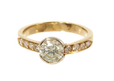 Lot 629 - Diamond single stone ring with a brilliant cut diamond estimated to weigh approximately 0.90cts in rubover setting with diamond set shoulders on 18ct gold shank