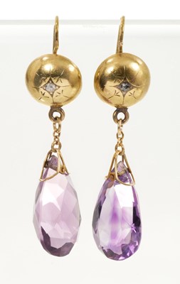 Lot 638 - Pair of late Victorian amethyst pendant earrings with a pear-cut amethyst suspended from a gold domed disc set with a rose cut diamond