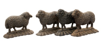 Lot 999 - Flock of four cast iron sheep doorstops, the largest 25cm long