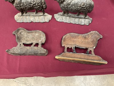 Lot 999 - Flock of four cast iron sheep doorstops, the largest 25cm long