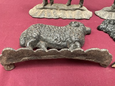 Lot 999 - Flock of four cast iron sheep doorstops, the largest 25cm long