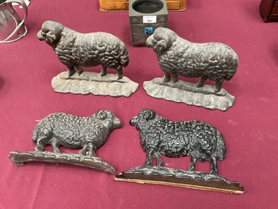 Lot 999 - Flock of four cast iron sheep doorstops, the largest 25cm long