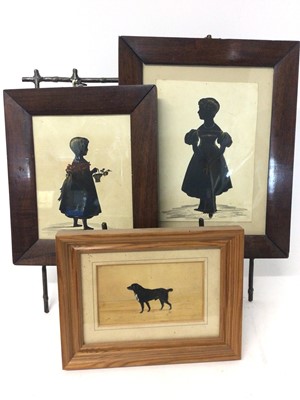 Lot 1123 - 19th century silhouette on paper, depicting a child with basket of flowers, 17 x 13cm, together with another of a child and a silhouette portrait of a collie dog, all framed. (3)