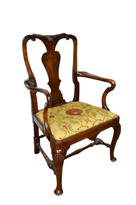 Lot 1513 - George I walnut open armchair, with carved top rail and solid splat, shepherds crook arms and slip in seat on shell carved cabriole legs, united by an H-shaped stretcher