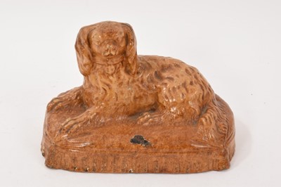 Lot 321 - Staffordshire stoneware model of a King Charles Spaniel, 19th century, shown seated on a cushion base, 19.5cm wide