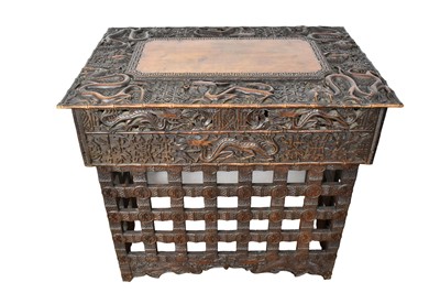 Lot 1555 - Chinese carved huanghuali desk, ornately relief carved with dragons and auspicious symbols, with one side drawer (one drawer missing) on lattice stand, 76cm wide x 51cm deep x 67cm high