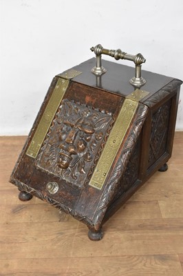 Lot 1559 - Victorian aesthetic period carved oak and brass bound purdonium, with carved lion mask to the hinged front, 37cm wide