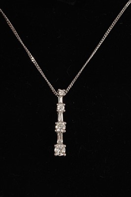 Lot 691 - Diamond pendant with graduated brilliant cut diamonds and tapered baguette cut diamonds in platinum setting on 18ct white gold chain