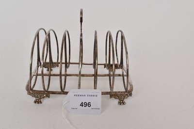 Lot 496 - George IV silver six division toast rack, with central carrying loop, on four paw feet