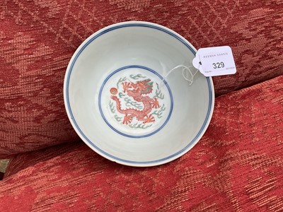 Lot 329 - A pair of Chinese porcelain bowls, Daoguang mark and period, decorated with a dragon and phoenix pattern in the Wucai style, 14.75cm diameter Provenance: brought home by Sir Francis Drum...