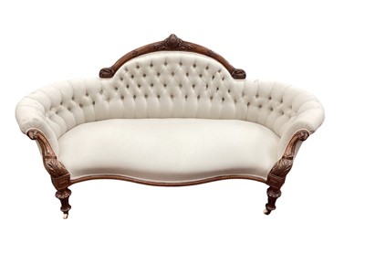 Lot 1646 - Good quality Victorian carved walnut framed sofa, the arched back, with carved cresting, upholstered on buttoned cream material, scroll arms, sepentine front on turned...