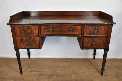 Lot 1612 - George III mahogany sideboard, with three quarter gallery and inverted bowed front with three drawers and deep cellarette drawer on ring turned tapered legs, 134cm wide x 53cm deep x 89cm high