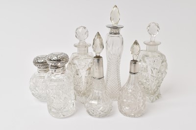 Lot 557 - Five silver topped cut glass scent bottles and two other (7)