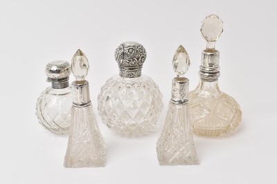 Lot 558 - Five silver mounted cut glass scent bottles