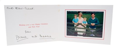 Lot 103 - T.R.H. The Prince and Princess of Wales, signed 1988 Christmas card with twin gilt Royal ciphers to cover, colour photograph of the Royal couple with their two sons resting on a gate, inscribed'...