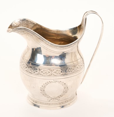 Lot 523 - George III silver cream jug of helmet form with bright cut engraved decoration