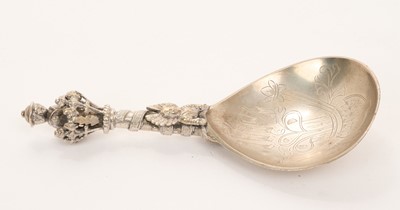 Lot 529 - Norwegian silver anointing spoon with engraved decoration and figural handle and terminal, marked 830s, MH (probably for Marius Hammer), 13cm in length.