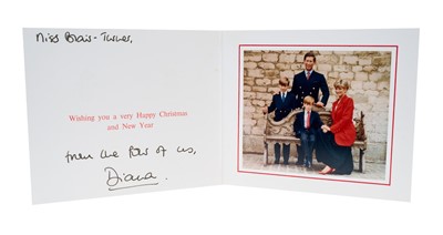 Lot 114 - H.R.H. Diana Princess of Wales, signed 1991 Christmas card with twin gilt Royal cyphers to cover, colour photograph of the Royal couple with their two sons seated on a wooden bench, inscibed 'Mis...