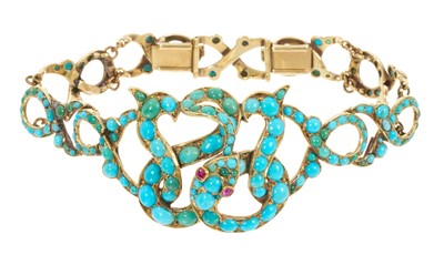 Lot 646 - Victorian gold and turquoise snake bracelet, the coiled gold snake with ruby eyes and turquoise cabochons with graduated articulated links, 17cm.