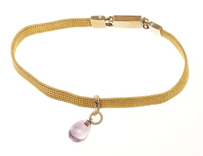 Lot 648 - Victorian gold mesh bracelet with a slide suspending an egg shaped amethyst drop