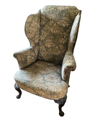 Lot 1681 - George I style wing armchair, raised on carved walnut cabriole legs