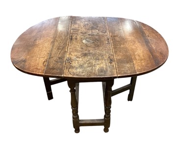 Lot 1694 - Late 17th / early 18th century oak drop leaf table, oval hinged top on turned and block understructure, 82 x 110cm