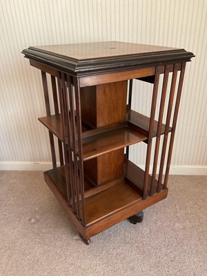 Lot 1412 - Early 20th century mahogany revolving bookcase, raised on castors, 49cm wide x 85cm high