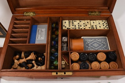 Lot 1179 - Edwardian mahogany games compendium with fitted interior comprising draughts, chess, backgammon, solitaire, dominoes, bezique, cribbage and classic steeplechase horse racing game