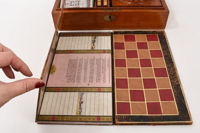 Lot 1179 - Edwardian mahogany games compendium with fitted interior comprising draughts, chess, backgammon, solitaire, dominoes, bezique, cribbage and classic steeplechase horse racing game