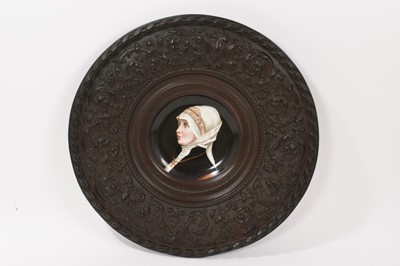 Lot 392 - 19th century continental porcelain dish painted with a portrait of a nun, in relief metal frame, total diameter 40.5cm