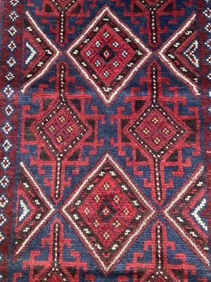 Lot 1750 - Bokhara runner with geometric design on red ground, approximately 245cm x 60cm