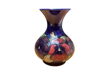 Lot 1140 - Moorcroft pottery vase decorated in the Pansy pattern, impressed marks and painted signature to base, 15.5cm high