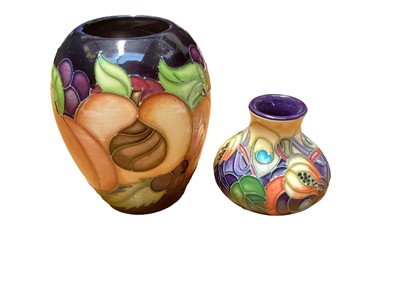 Lot 1149 - Moorcroft pottery vase decorated in the Pomegranate Reborn pattern, dated 2009, together with another decorated in the Celtic Web pattern, dated 2002 (2)