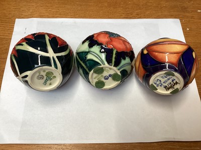 Lot 1151 - Three Moorcroft pottery vases including Poppy, dated 96, trial, and Scarlet, dated 2007, all 8.5cm