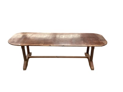 Lot 1733 - African nara wood refectory table, with rounded rectangular top on trestle ends united by a foot stretcher, 244c, wide x 83cm deep x 75cm high