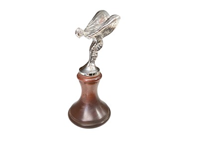 Lot 62 - Rolls-Royce Silver Seraph Spirit of Ecstasy mascot marked 'Rolls-Royce Motors Ltd' on turned wood display plinth, 17.5cm overall.