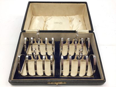 Lot 283 - Set of four 1930s silver toast racks in fitted case (Birmingham 1932) by Adie Brothers Ltd.