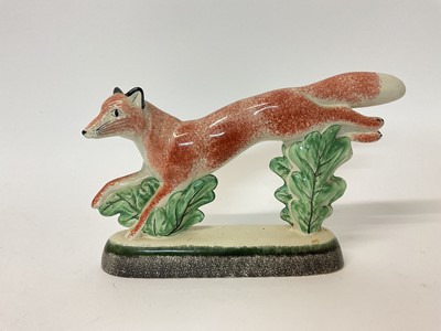 Lot 70 - Rye Pottery model of a running fox, dated 2004 to base, 17cm high x 27cm long