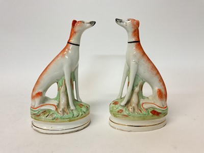 Lot 71 - Pair of Victorian-style Staffordshire pottery models of seated greyhounds, 23cm high