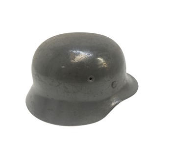 Lot 735 - Second World War Nazi M40 helmet with grey painted finish, stamped under brim 11388, with brown leather lining and chin strap.