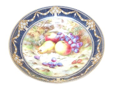 Lot 1193 - Frank Roberts for Royal Worcester, a fruit painted bowl, circular form, decorated with apples, peaches and grapes on a naturalistic ground, within a black and white chevron and striped border wi...