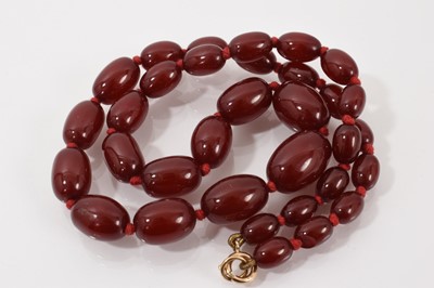 Lot 119 - Simulated cherry amber graduated oval bead necklace with 9ct gold clasp, 49.5cm long