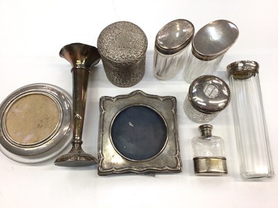 Lot 120 - Group of silver mounted glass dressing table jars/bottles, silver spill vase, silver photograph frame and a white metal foliate pot and cover