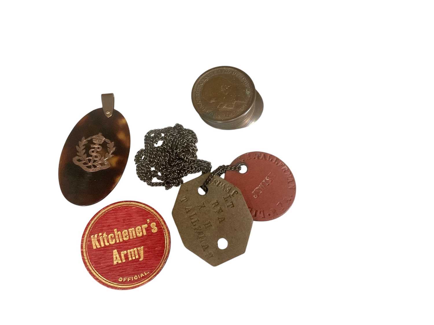 Lot 808 - First World War Kitchener's Army official badge, tortoiseshell and piquet work Royal Army Medical Corps pendant, dog tags and Trench Art cap made from a penny.