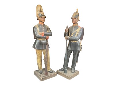 Lot Pair of Franco Prussian War period painted terracotta figures of Imperial German Guard Artillery and Guard Infantry soldiers, standing with their rifles, the larger 30.5cm in height.